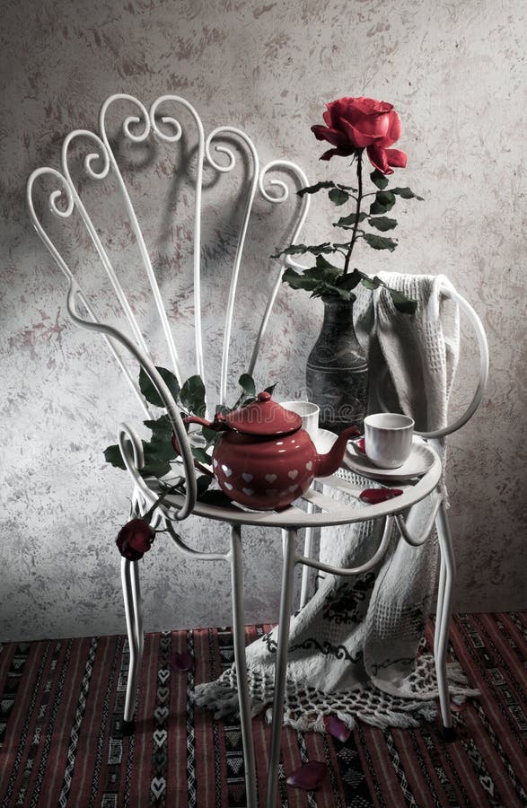 Still life with antique chair, rose and tea