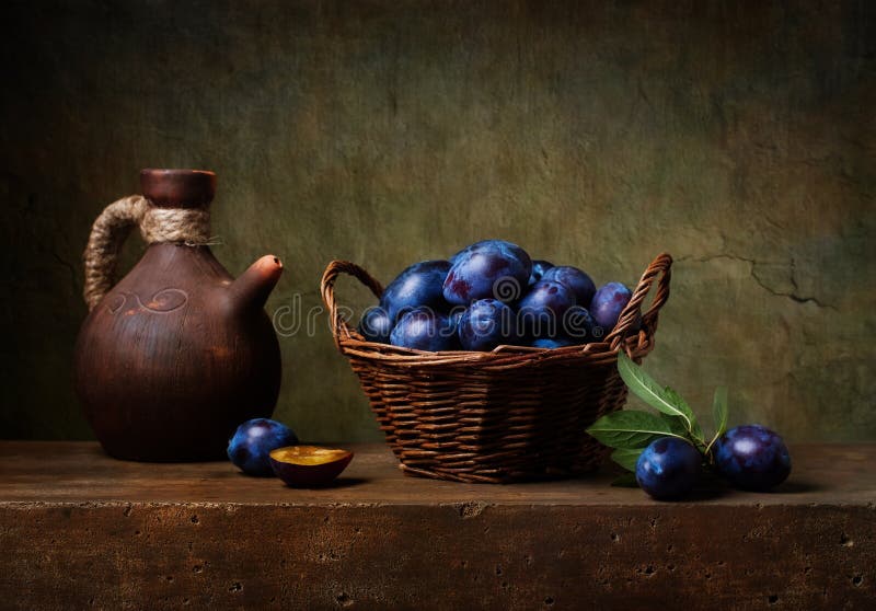 Still life with black plums in a basket