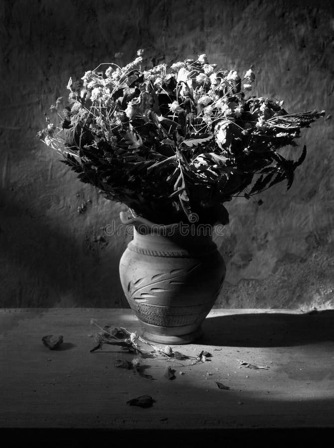 Still life with black and white bouquet of dried roses in black and white