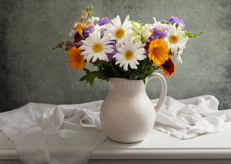 Still life with bouquet of summer flowers in a jar