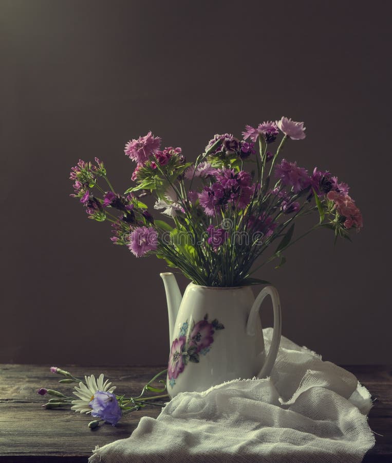 Still life lilac flowers in a vase on the table Stock Photo by