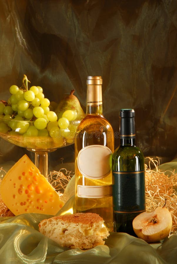 Still life with cheese, bread, grapes and two bott