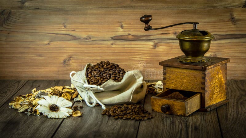 Still life with coffee, grinder and flowers. Vintage style.