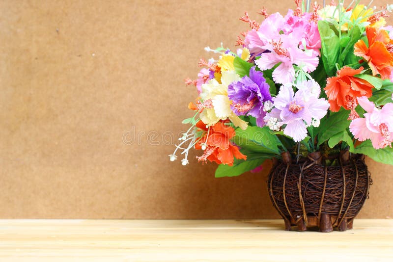 Still life with colourful flower bunch in wood vase on wooden table and copy space