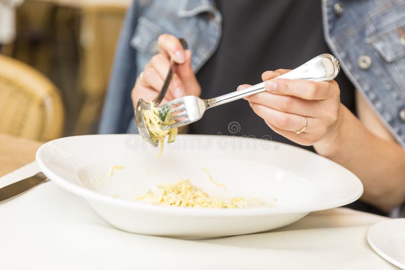 Still life concept. Woman eating dinner at restaurant