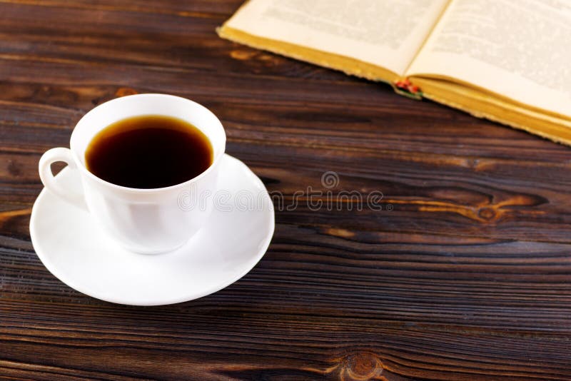 Still life with cup of coffee and book on grunge wood table in vintage style stock photo Still life with cup of coffee and book on grunge wood table in vintage style stock photo