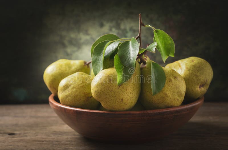 Still life with fresh pears with leaves in a bowl