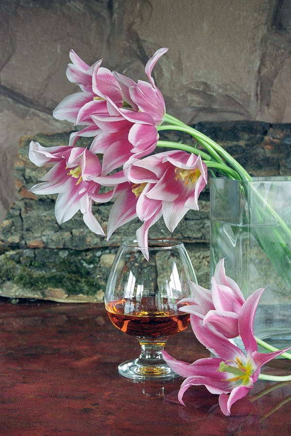 Still-life with a glass of brandy and flowers