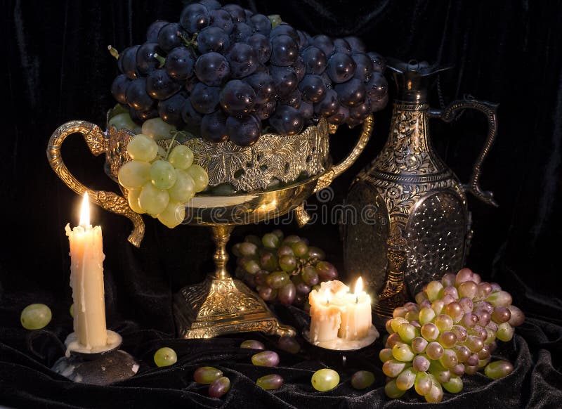 Still life with grape in vase and candles