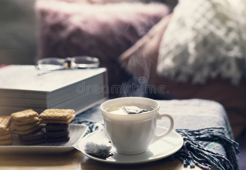 Still life Hot cuppa tea with steam on a coffee table with morning light or Can be Cozy scene of relaxing in afternoon tea served