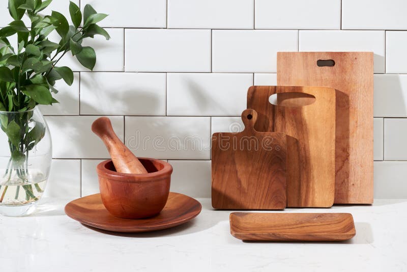 Set of kitchen ceramic tableware and wooden cutting boards on a table. Eco  style home still life. Stock Photo by Edalin