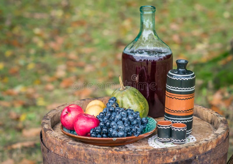 Still life on oak barrel of fruit and red wine autumn