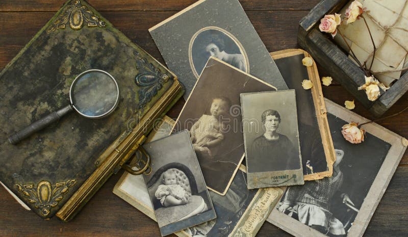 Still-life with old photo album and historical photos of family.