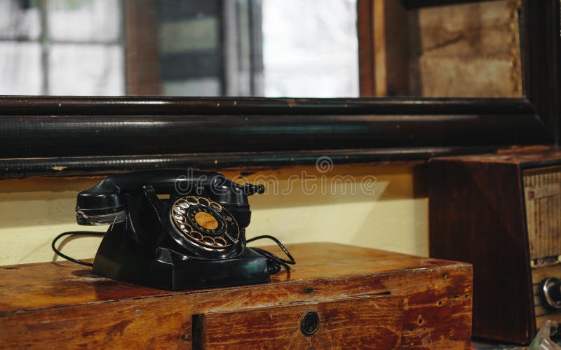 Still life of old vintage retro black telephone on asia style wood table in vintage retro room stock photo Still life of old vintage retro black telephone on asia style wood table in vintage retro room stock photo