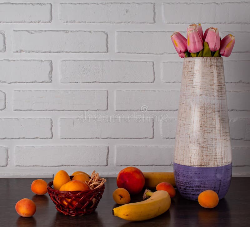 Still Life of Peaches in a Ceramic Vase with Flowers Stock Image