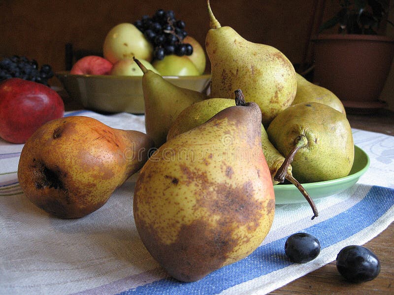 Still life of red apples, green pears and grapes on towel stock photo