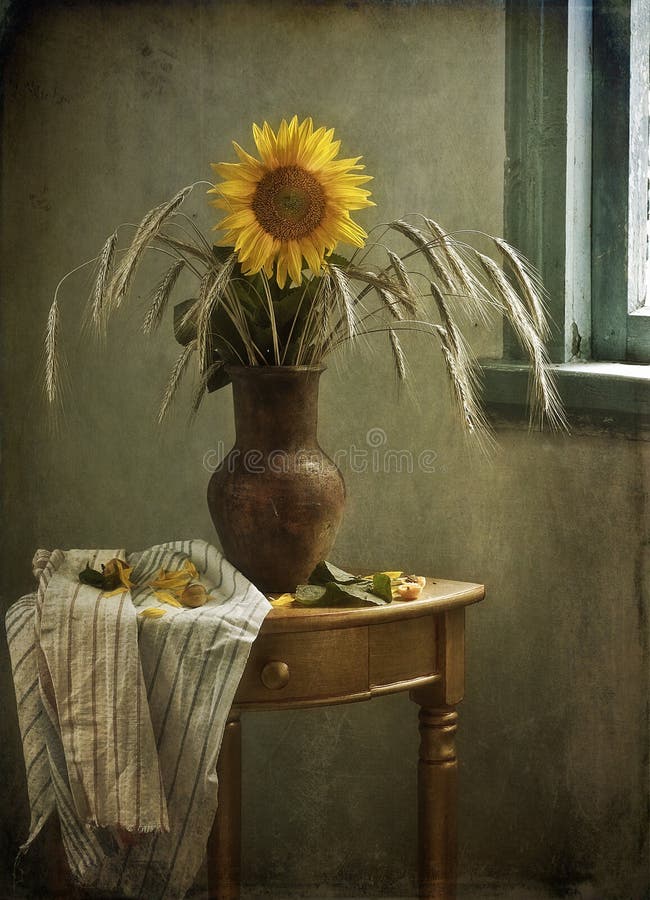 Still life with a sunflower and ears