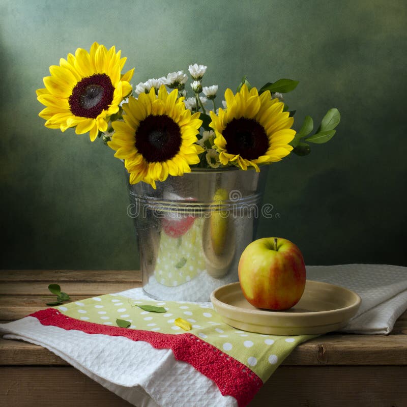 Still life with sunflowers and apple
