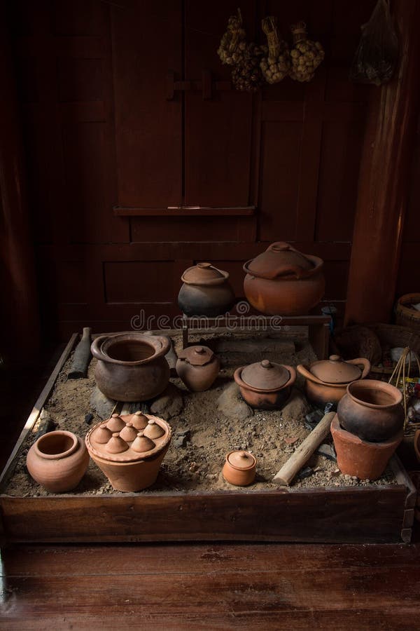 Thai Kitchen Cooking Utensils Hung on Traditional Wood Wall Stock Photo