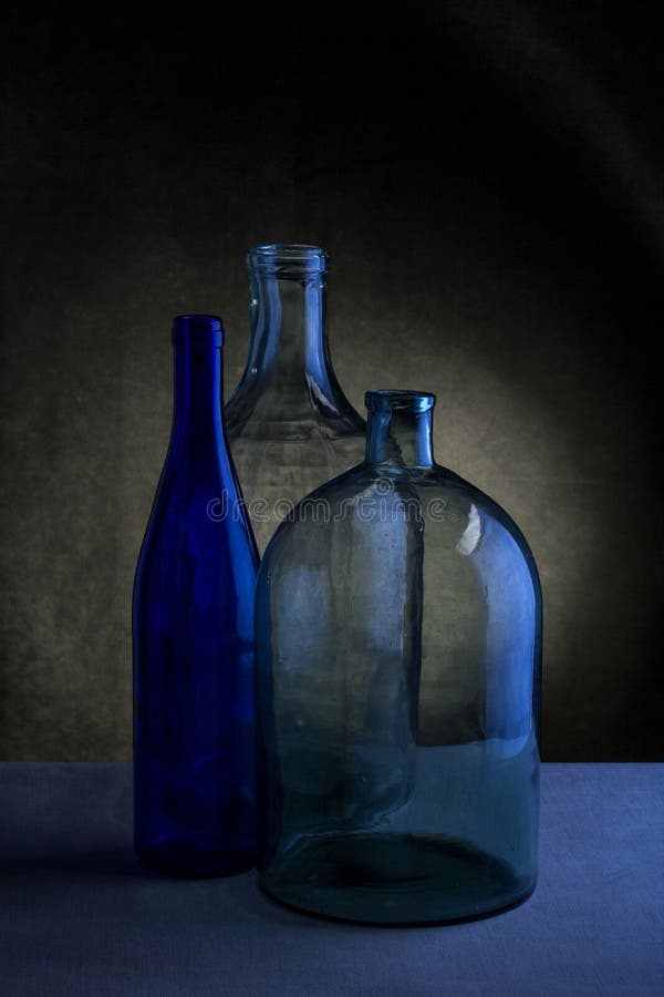 Still Life With Three Glass Bottles Stock Photo Image of light, table 141613390
