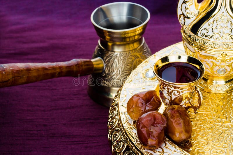 Still life with traditional golden arabic coffee set with dallah, coffee pot (jezva), cup and dates. Dark background. Horizontal. Still life with traditional stock photography Still life with traditional golden arabic coffee set with dallah, coffee pot (jezva), cup and dates. Dark background. Horizontal. Still life with traditional stock photography