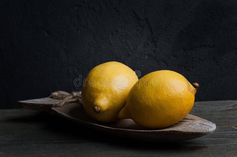 Still life with two lemons. Dark style