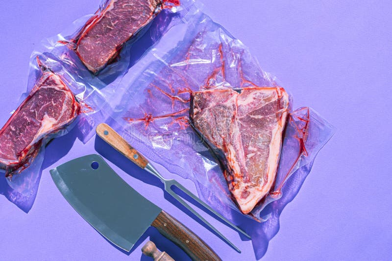 Still Life of Vacuumpacked Meat with Herbs and Butcher`s Tools Stock