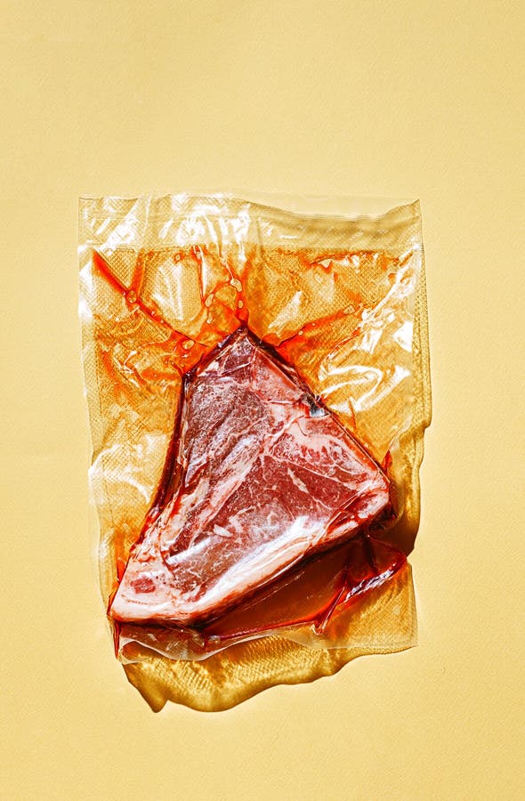 Still Life of Vacuumpacked Meat with Herbs and Butcher`s Tools Stock