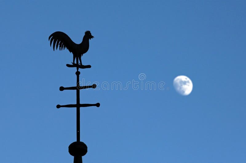 Still life of weathercock and moon in blue sky stock image Still life of weathercock and moon in blue sky stock image
