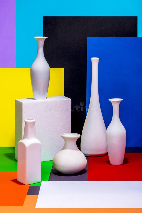 Still life with white vases on a color abstract background. Cardboard color shapes stock images, royalty-free photos and pictures