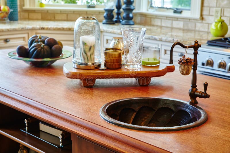 Image of Still life of an antique kitchen with a wooden countertop, deep basin sink, and accoutrements. Image of Still life of an antique kitchen with a wooden countertop, deep basin sink, and accoutrements