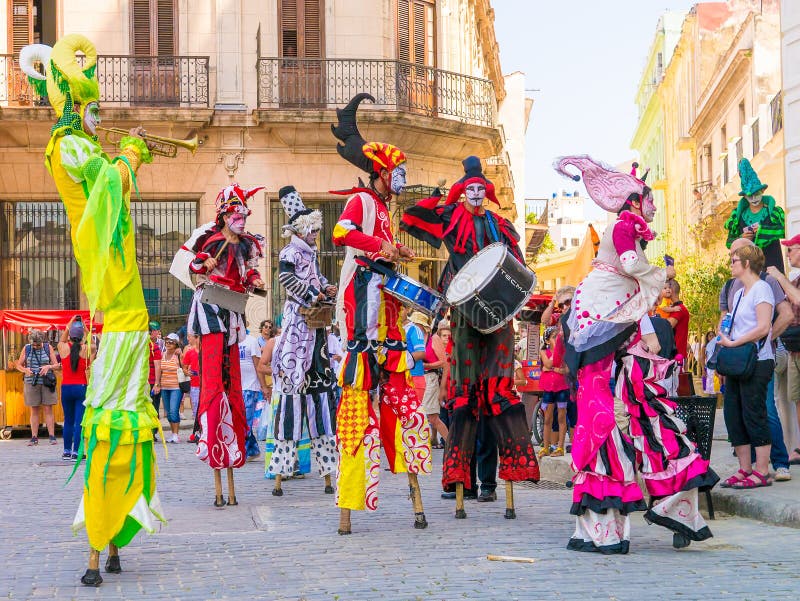 Colorful stiltwalkers dancing to the sound of cuban music in Old Havana. Colorful stiltwalkers dancing to the sound of cuban music in Old Havana