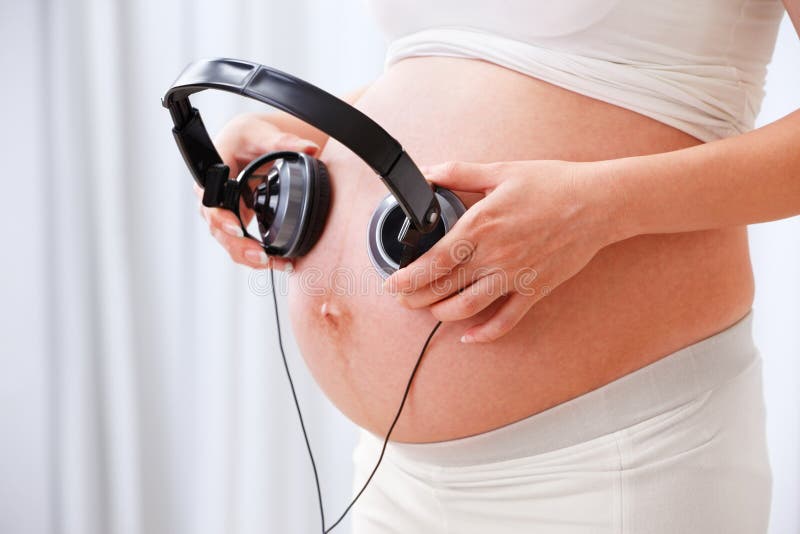 Stimulating the fetus using music stock images