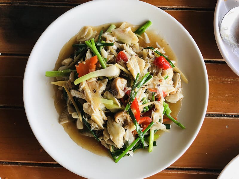Stir fried crab meat with spring onion and straw mushroom. royalty free stock photo