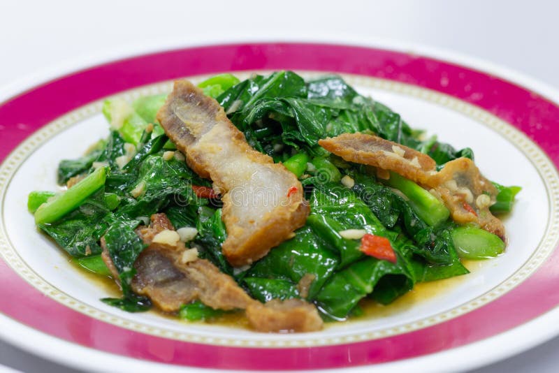 Stirfried Kale Vegetable with Crispy Pork. Thai Food Stock Image