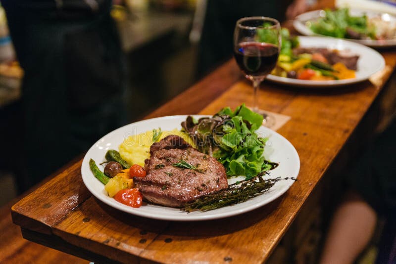 Stir fried pork steak served with vegetable side dish, salad and mash potato topping with balsamic dressing. stock image Stir fried pork steak served with vegetable side dish, salad and mash potato topping with balsamic dressing. stock image