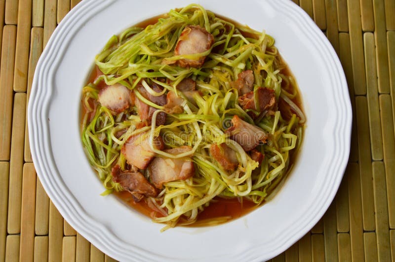 Stirfried White Garlic Chives with Crispy Pork on Dish Stock Image
