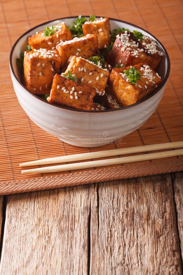 Stir Fry dish: tofu cheese with sesame seeds in a bowl close-up