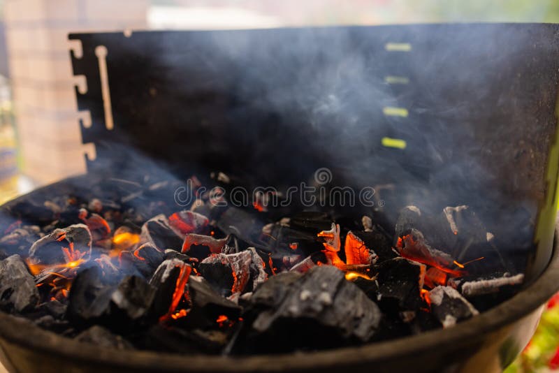 Stock Image of Charcoal Fire Grill, Close Up with Live Flames. Stock