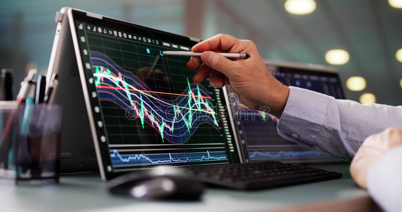 Stock Market Broker Looking At Graphs On Multiple Screens royalty free stock photos