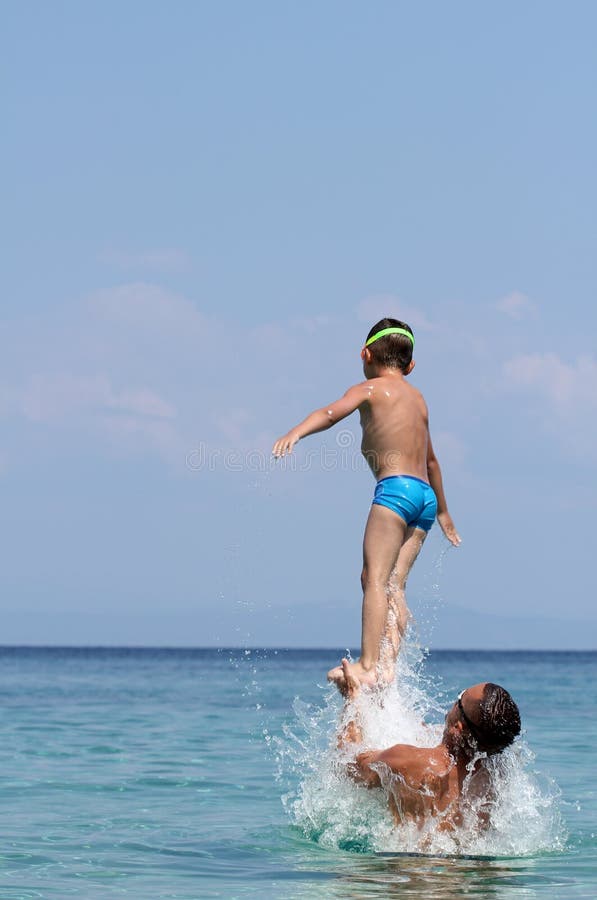 Father and son play in water