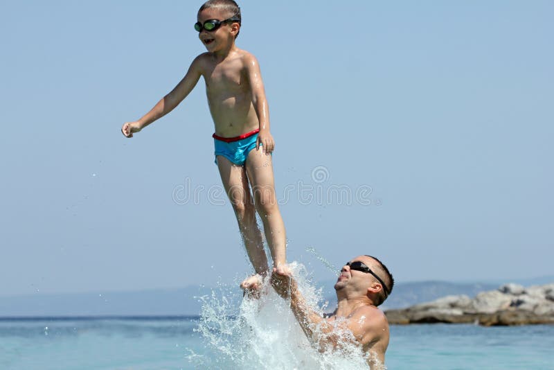 Father and son play in water