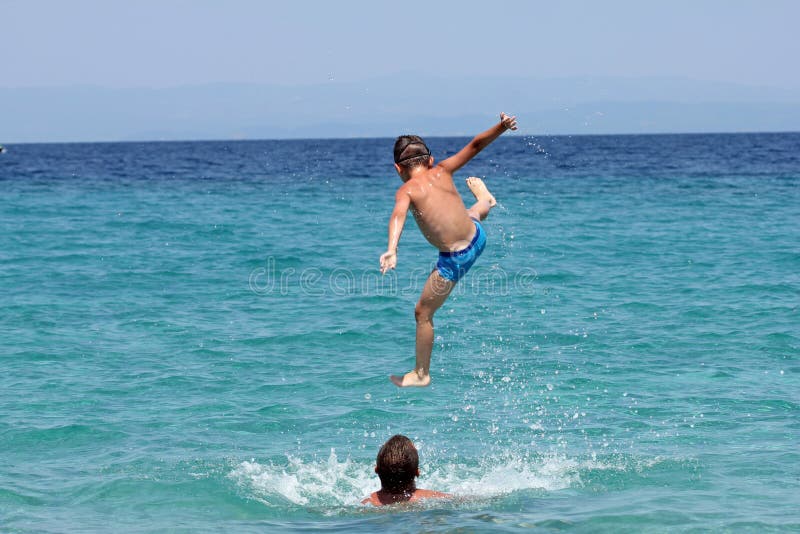 Father and son play in water