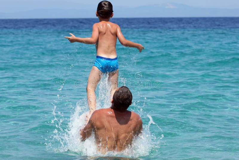 Father and son play in water