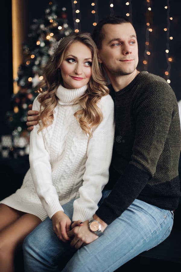Couple on bed with Christmas present. New Year stock image Couple on bed with Christmas present. New Year stock image