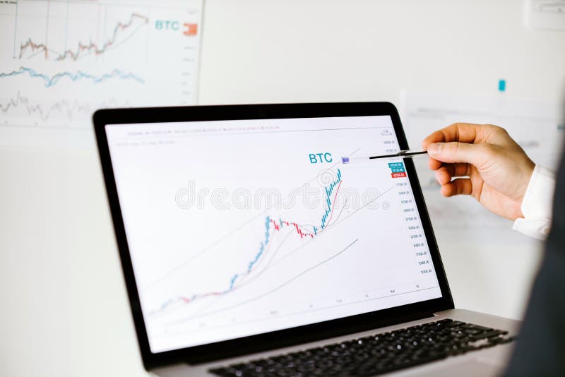 Stock trader bitcoin price trend graph analysis on laptop stock image