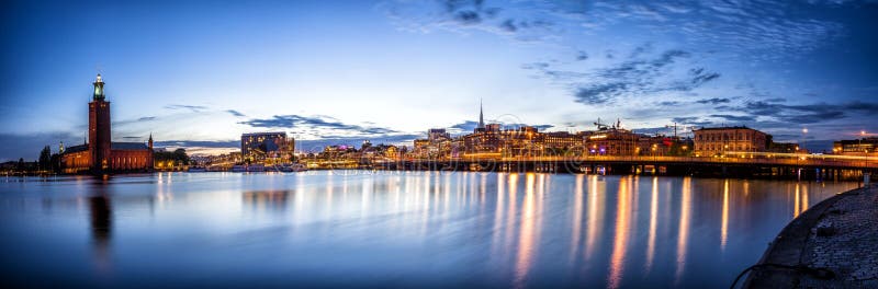 Stockholm sunset skyline panorama with City Hall. Stockholm sunset skyline with City Hall as seen from Riddarholmen. Panoramic montage from 13 images royalty free stock image Stockholm sunset skyline panorama with City Hall. Stockholm sunset skyline with City Hall as seen from Riddarholmen. Panoramic montage from 13 images royalty free stock image
