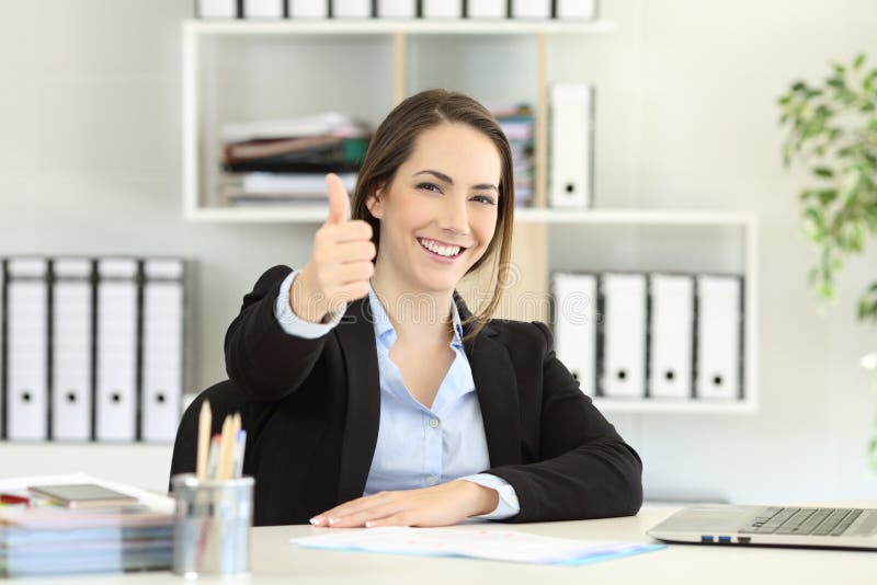 Proud office worker posing with thumbs up looking at camera. Proud office worker posing with thumbs up looking at camera