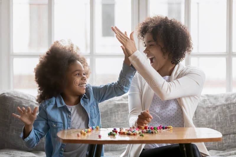 Stolze Mutter, der Tochter hoch fünf gibt lizenzfreie stockfotografie