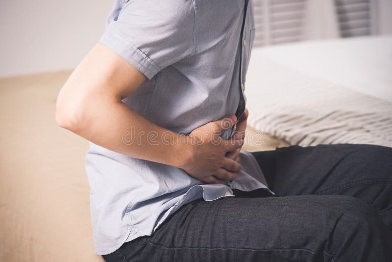 Stomach ache, man with abdominal pain suffering at home. Spasm ache stock images, royalty-free photos and pictures